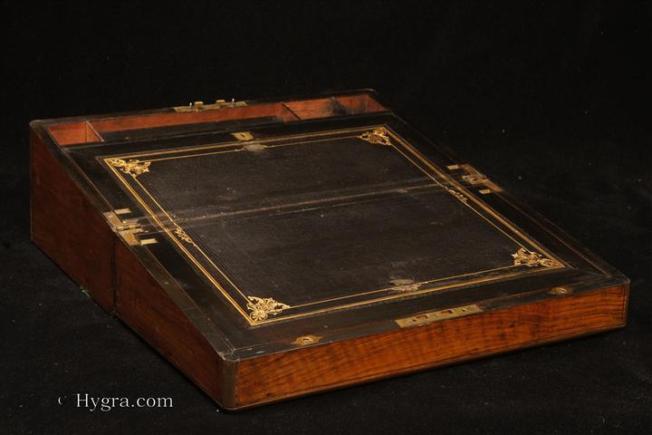 Writing box veneered in figured walnut, with rounded brass surround and brass lines. Strong Bramah lock.Enlarge Picture